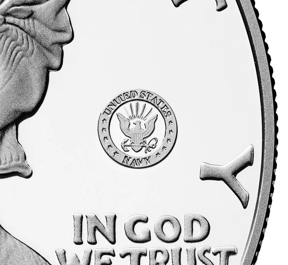 Close up of the American eagle silver dollar featuring the US Navy 250th anniversary privy mark consisting of a circular emblem that reads 'UNITED STATES NAVY' surrounding the Navy insignia.